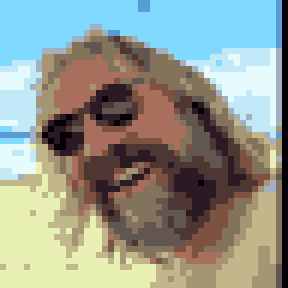 Mike Fitzback in 8-bit pixel art: long blond hair, sunglasses, a big grey beard and a grin, on a beach